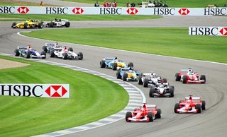 Cars wind through the infield section at Indianapolis Motor Speedway at the start of the 2003 USGP