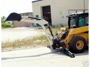 Skid loader with bucket replaced by backhoe attachment
