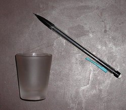 A shot glass (pencil included for scale)