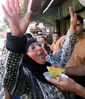 This woman said she was offered a piece of cake for celebrating in front of the camera. (Fair use of AP photo)