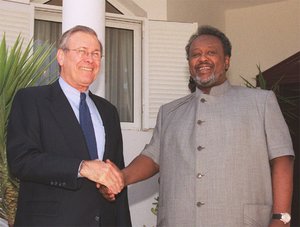 U.S. Secretary of Defense Donald Rumsfeld and Djibouti President Ismail Omar Guelleh shake hands at the Presidential residence in Djibouti