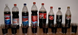 Several differnt brands of cola. (PEPSI, TAUfrisch Cola, PEPSI MAX, River Cola, Coca-Cola, Sinalco Cola, afri Cola, Coca-Cola light)