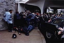 Chaos outside the Washington Hilton Hotel after the assassination attempt on President Reagan. James Brady and police officer Thomas Delahanty lie wounded on the ground.