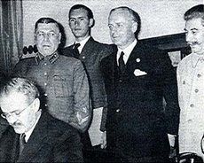 Molotov (lower left), Ribbentrop (in black) and Stalin (far right)