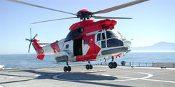 An  helicopter touches down on a helipad onboard the High Speed Vessel Swift (HSV 2) ship.