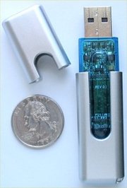 A USB flash drive, shown with a 24 mm  for scale.