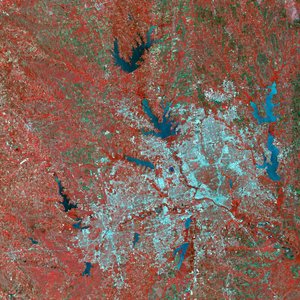 A simulated-color satellite image of Dallas and , Texas, taken by NASA's Landsat 7 satellite. Dallas makes up much of the right half of the urbanized area. Red is vegetated area surrounding DFW.  Notice also the many reservoirs in the area.