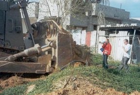 Corrie hours before her death, protesting in front of an IDF  bulldozer