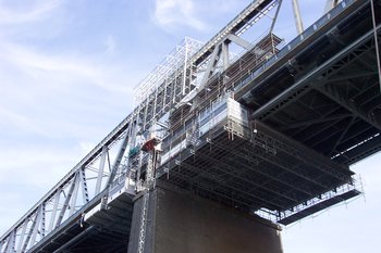 A mobile maintenance scaffold attached to the bridge