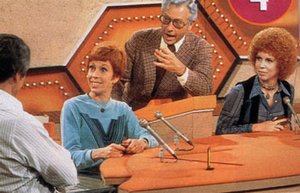 Allen Ludden, as emcee of Password, presiding over a round with celebrity guests  (left) and  (right).