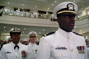Newly graduated and commissioned officers of the Naval Reserve Officers Training Corps (NROTC) Unit Hampton Roads stand at attention as they are applauded during the Spring Commissioning Ceremony