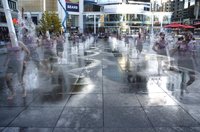 A jogger cools off in the "urban beach" that forms the main central part of Dundas Square (multiple exposure picture).