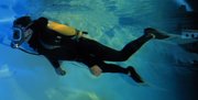 A diver in a pool wearing an AGA full face mask