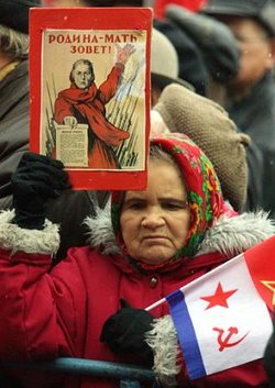 Increasingly impoverished and marginalized, elderly pensioners and fixed income laborers have grown increasingly disillusioned with economic reforms, contributing to growing nostalgia for Soviet days. The caption on the poster, a patriotic slogan from World War II, reads, "The Motherland is Calling!"