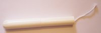 'A tampon with applicator.  The leftmost part is the bigger tube, which has a smooth surface and a round end for easier insertion. There's a star shape openning at the round end. The tampon itself rests inside the bigger tube. (The tube shown is made of cardboard)  The middle section is the narrower tube. It nested inside one end of the bigger tube. The narrow tube slides into the bigger tube, pushing the tampon through and into the vagina.  Both tubes (the applicator) are withdrawn after the tampon is inserted.  The string by right end, would be hanging out of the vagina, allows for easy extraction. 