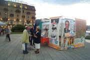 A street stall for the all United in the Olive Tree coalition, during campaigning for the European Parliament elections 2004, seen in Como, Italy. Note that the poster shows Romano Prodi and roundels (party electoral/ballot logos) for each of the constituent parties in the coalition.