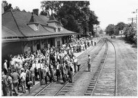 API Cadets and students wait at the train station for trains to Atlanta or Montgomery, circa 1943