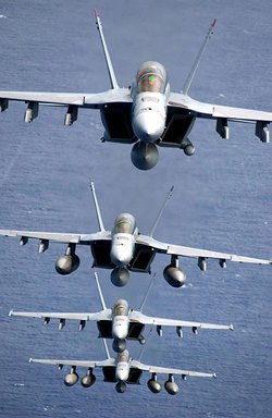 Four F/A-18 E/F Super Hornets assigned to the "Black Aces" of Strike Fighter Squadron Forty One (VFA-41) fly over the Western Pacific Ocean in a stack formation. Taken October 25th 2003