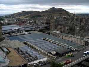 Waverley Station, from the .Waverley Bridge is at the bottom right, North Bridge in the middle heading right (southward) to the old town.  Arthur's Seat is in the background.