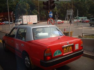 An urban red taxi in Hong Kong.