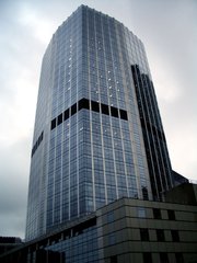 A view of the skyscraper from a pedestrian bridge crossing .